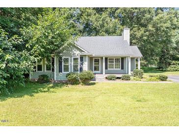 Charming one-story home with a well-maintained lawn and mature trees at 2474 Sumter Dr, Garner, NC 27529