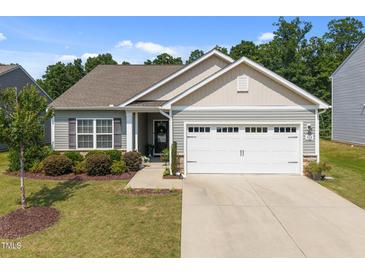 Charming single-story home with a two-car garage, well-manicured lawn, and inviting curb appeal at 515 Legacy Dr, Youngsville, NC 27596