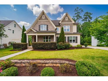 Charming two-story home with a beautifully landscaped front yard and stone accents at 610 Bennett Mountain, Chapel Hill, NC 27516