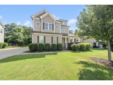 Charming two-story home with manicured lawn, neutral siding and black shutters at 1123 Ambrose Dr, Rolesville, NC 27571