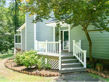 Charming front porch with white railings and steps leading to the welcoming entrance at 2849 Rue Sans Famille, Raleigh, NC 27607