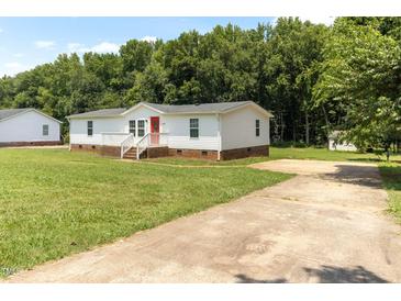Charming home with a well-maintained lawn and a cozy front porch at 2932 Bramblegate Dr, Mebane, NC 27302