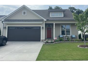 Charming single-story home featuring a cozy front porch and a well-manicured lawn at 3 Meadowrue Ln, Youngsville, NC 27596