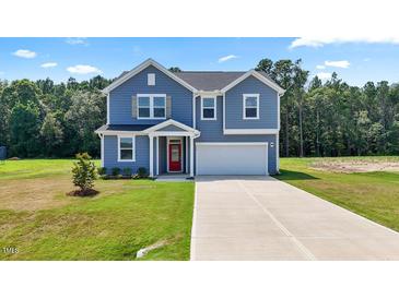Inviting two-story home featuring a well-manicured lawn, attached garage and classic architectural details at , Fuquay Varina, NC 27526