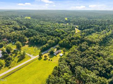 Expansive aerial view of the property with lush greenery, a home, and a winding road at 3701 Oak Grove Church Rd, Mebane, NC 27302