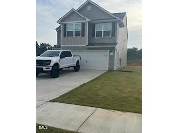 Charming two-story home with a gray exterior, front-facing garage, and a well-maintained lawn at 484 Crow Field St, Roxboro, NC 27574