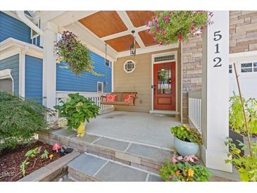 Inviting front porch with swing and charming details at 512 Mill Hopper Ln, Apex, NC 27502