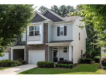 Charming townhome with attached garage, well-manicured lawn, and welcoming covered entrance at 6147 Beale Loop, Raleigh, NC 27616