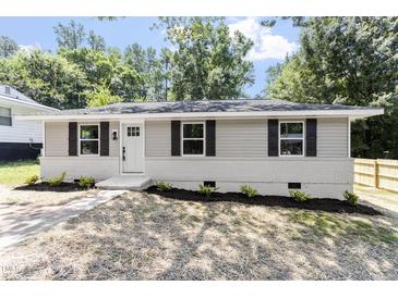Charming single story home with gray siding, black shutters, and freshly landscaped front yard at 768 Lunar Dr, Raleigh, NC 27610