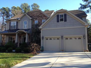 Charming two-story home with stone accents and a two-car garage at 8228 Clarks Branch Dr, Raleigh, NC 27613