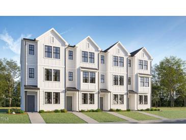 Charming new construction townhome featuring a modern farmhouse facade and a well manicured front yard at 1525 Crescent Townes Way, Raleigh, NC 27604