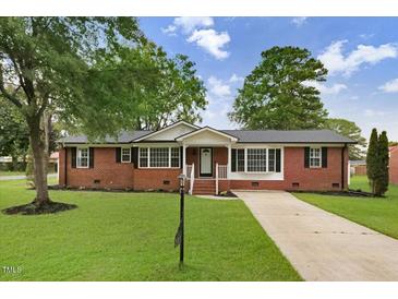 Charming brick home featuring a well-maintained lawn and classic architectural details at 201 Shady Lane Dr, Smithfield, NC 27577