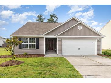 Charming single-story home featuring neutral siding, a two-car garage, and a well-manicured lawn at 2040 Alderman Way, Creedmoor, NC 27522