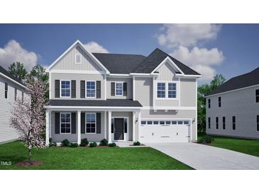 Charming two-story home featuring a covered front porch and a two-car garage in a well-kept neighborhood at 105 Guardian St, Youngsville, NC 27596