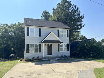 Charming two-story home featuring a welcoming entrance and a spacious driveway at 2907 S S Roxboro St, Durham, NC 27707