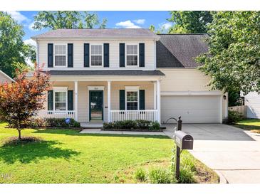 Charming two-story home with a welcoming front porch and a well-manicured lawn at 3201 Sawyers Mill Dr, Apex, NC 27539