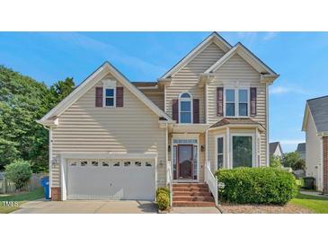 Charming two-story home with neutral siding, brick steps, a two-car garage, and manicured front landscaping at 3212 Marblewood Ct, Raleigh, NC 27604