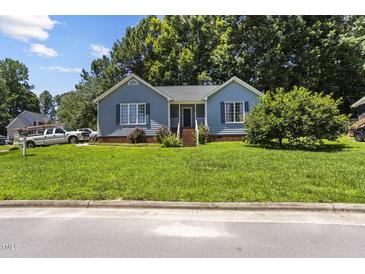 Charming blue home featuring a well-manicured front yard and inviting entrance at 5105 Baywood Forest Dr, Knightdale, NC 27545