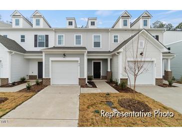 Charming townhome with a single-car garage and inviting entrance at 67 Little Leaf Ln # 98, Clayton, NC 27527