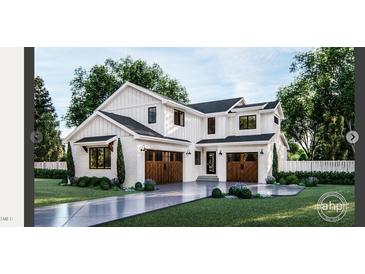 Stunning two-story home with a modern farmhouse design, featuring white siding and a two-car garage at 8014 Penny Rd, Raleigh, NC 27606