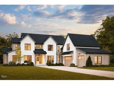 Stunning two-story home with a modern farmhouse aesthetic, complemented by lush green landscaping at 8016 Penny Rd, Raleigh, NC 27606