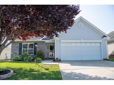 Charming single-story home with well-maintained lawn and an attached two-car garage at 326 Slate Dr, Gibsonville, NC 27249