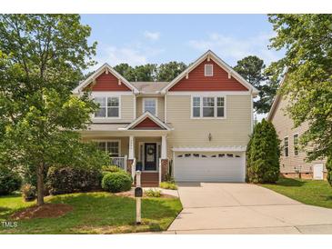 Inviting two-story home featuring a charming front porch and a convenient two-car garage at 3806 Stoneybrook Dr, Durham, NC 27705