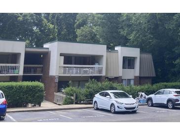 Well-maintained condo building with lush greenery and convenient visitor parking at 500 Umstead Dr # D307, Chapel Hill, NC 27516