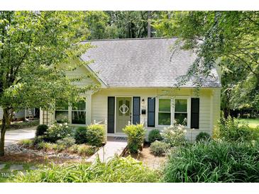 Charming home featuring a well-manicured front yard, a light exterior, and a welcoming entrance at 711 W Carver St, Durham, NC 27704