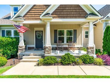 Inviting front porch with rocking chairs and an American flag for a warm and welcoming feel at 20 Kola Nut, Smithfield, NC 27577