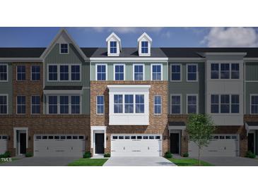 Charming townhome with brick and siding exterior, dormer windows, and attached two-car garage at 2118 Pink Peony Cir # 151, Durham, NC 27703