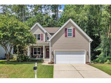Charming two-story home featuring a well-manicured lawn and a two-car garage at 213 N Weststone Blvd, Fuquay Varina, NC 27526