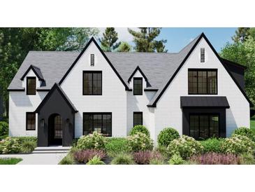 Stunning new construction featuring a white brick facade, sleek black trim, and manicured landscaping at 4348 Coldwater Springs Dr, Raleigh, NC 27616