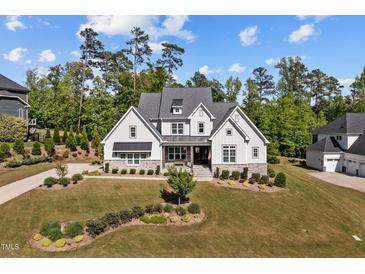 Beautiful two-story home featuring a manicured lawn and a stone-accented facade at 623 Westfall Way, Chapel Hill, NC 27517
