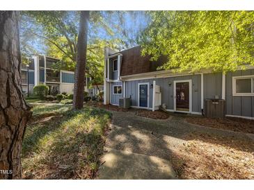 Charming two-story townhouse with a well-maintained lawn and beautiful surrounding trees at 7020 Longstreet Dr # A, Raleigh, NC 27615