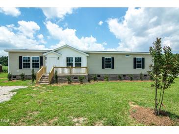 Charming manufactured home with a well-maintained lawn and inviting front porch at 100 Cottonwood Ct, Kenly, NC 27542