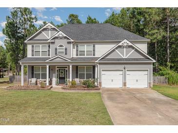 Charming two-story home with a welcoming front porch and a two-car garage at 115 Baystone Dr, Sanford, NC 27332