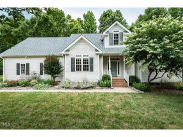 Charming single-Gathering home features a well-manicured lawn, welcoming front porch, and traditional architecture at 906 Stuart Dr, Mebane, NC 27302