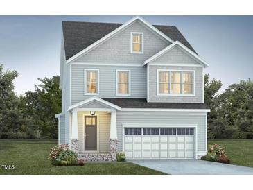 Charming two-story home with gray siding, attached garage, and landscaped lawn at 1221 Barreto Dr, Wendell, NC 27591