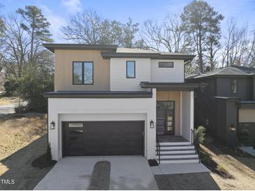 Modern two-story home with dark garage door and light-colored siding at 2601 Mayview Rd, Raleigh, NC 27607