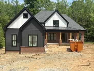 Stunning new construction home with a modern farmhouse design, featuring gray siding and brick accents at 72 Hazelwood, Pittsboro, NC 27312