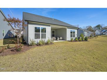 The beautiful backyard features a covered patio and well-maintained lawn at 2009 Abbeyhill Dr # 63, Raleigh, NC 27610