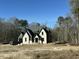 Stately two-story home featuring a complex roofline and a neutral color palette, nestled on a spacious lot with mature trees at 3812 Peaceful Creek Trl, Zebulon, NC 27597
