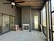 An unfinished screened porch with a fireplace and sliding glass doors at 3812 Peaceful Creek Trl, Zebulon, NC 27597