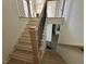 A view of an unfinished staircase featuring natural wood, white walls, and a black railing at 3812 Peaceful Creek Trl, Zebulon, NC 27597