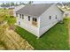 Back exterior of home features a walk-out basement, small deck, and newly seeded lawn at 164 Clove Hitch Ln, Fuquay Varina, NC 27526