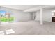 Large finished basement area features neutral carpet, stairs, and sliding glass doors to the yard at 164 Clove Hitch Ln, Fuquay Varina, NC 27526