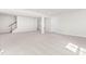 Neutral basement features carpeted floors, stairs, and a doorway to a bathroom at 164 Clove Hitch Ln, Fuquay Varina, NC 27526