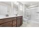 Bathroom featuring double sinks, modern fixtures, and a glass-enclosed shower for a sleek and functional design at 164 Clove Hitch Ln, Fuquay Varina, NC 27526