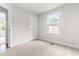 Cozy bedroom with soft carpeting, a window overlooking the neighborhood, and a convenient closet for ample storage space at 164 Clove Hitch Ln, Fuquay Varina, NC 27526
